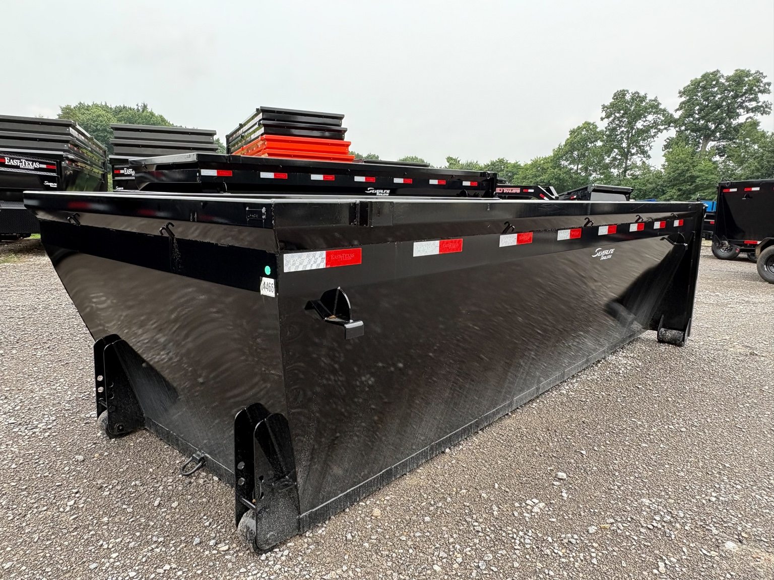Black roll-off dumpster viewed from the side